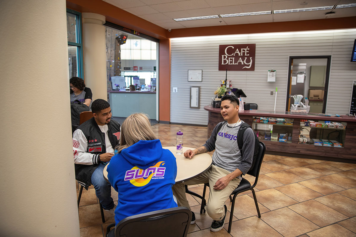 Three students sitting in SJC HHPC Cafe Belay