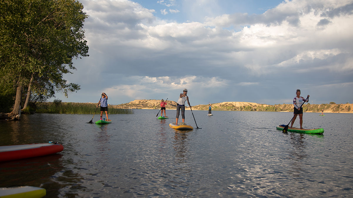 People on San Juan College's Stand Up Paddle Boards at Farmington Lake