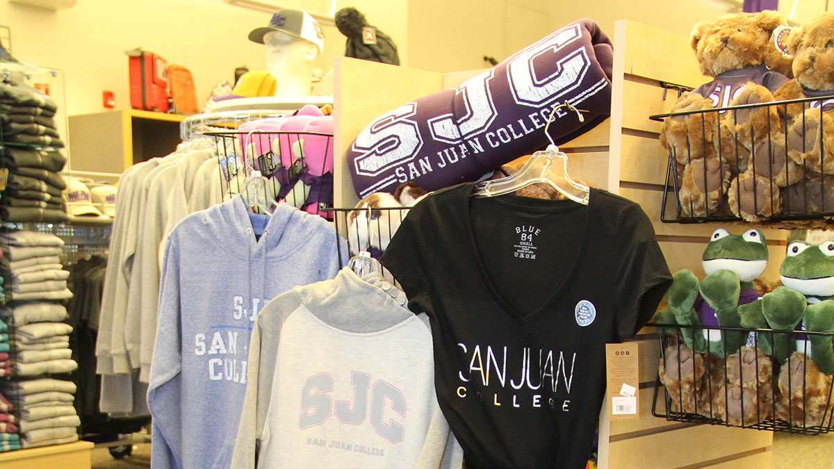 A variety of SJC merchandise, hoodies, sweaters, blankets and bears.
