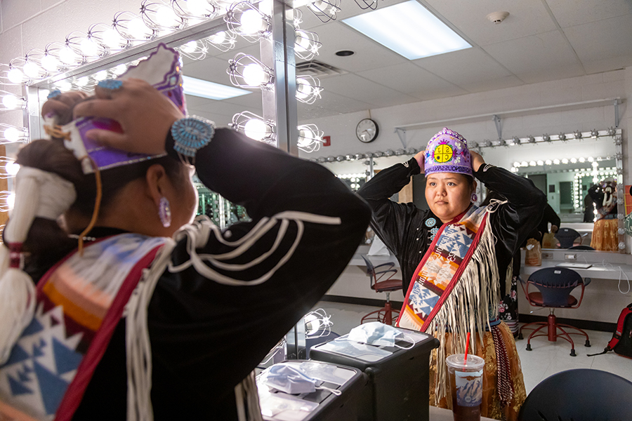 San Juan College Ms. Indigenous looking at herself in the mirror during the Ms. Indigenous pagent.