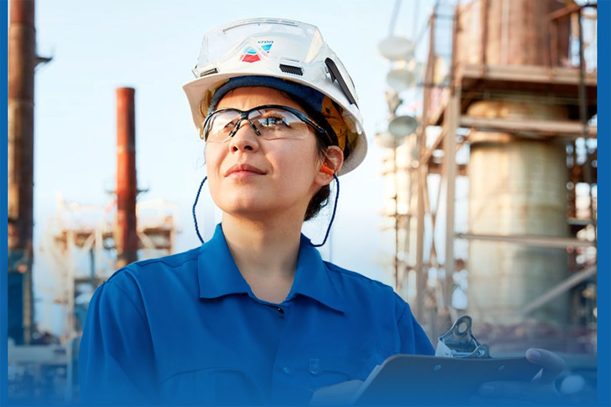 Female in her Chevron uniform and hard hat on a job site.