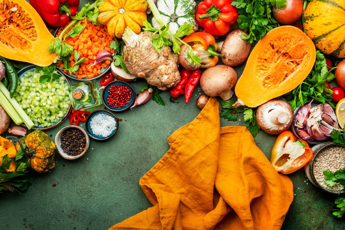 Collection of vegetables, mushrooms, squash, chopped onions and a napkin.