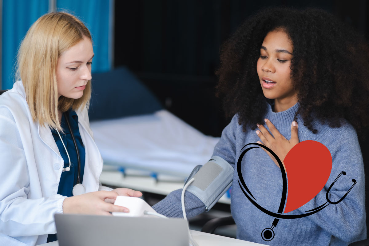 Two women sitting at a table and the women on the right getting her blood pressure taken with a heart to the right