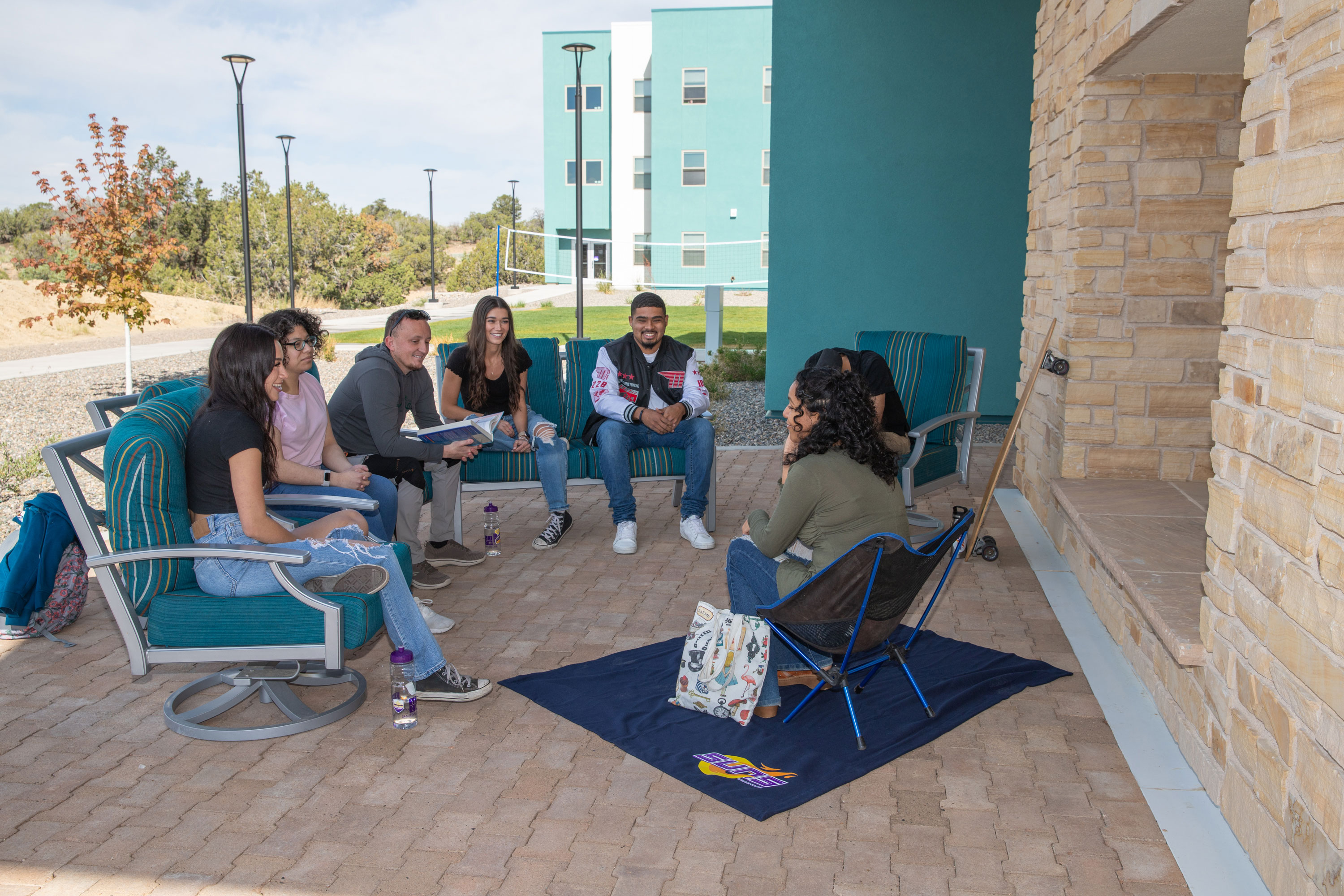 Group of SJC students sitting together and chatting.