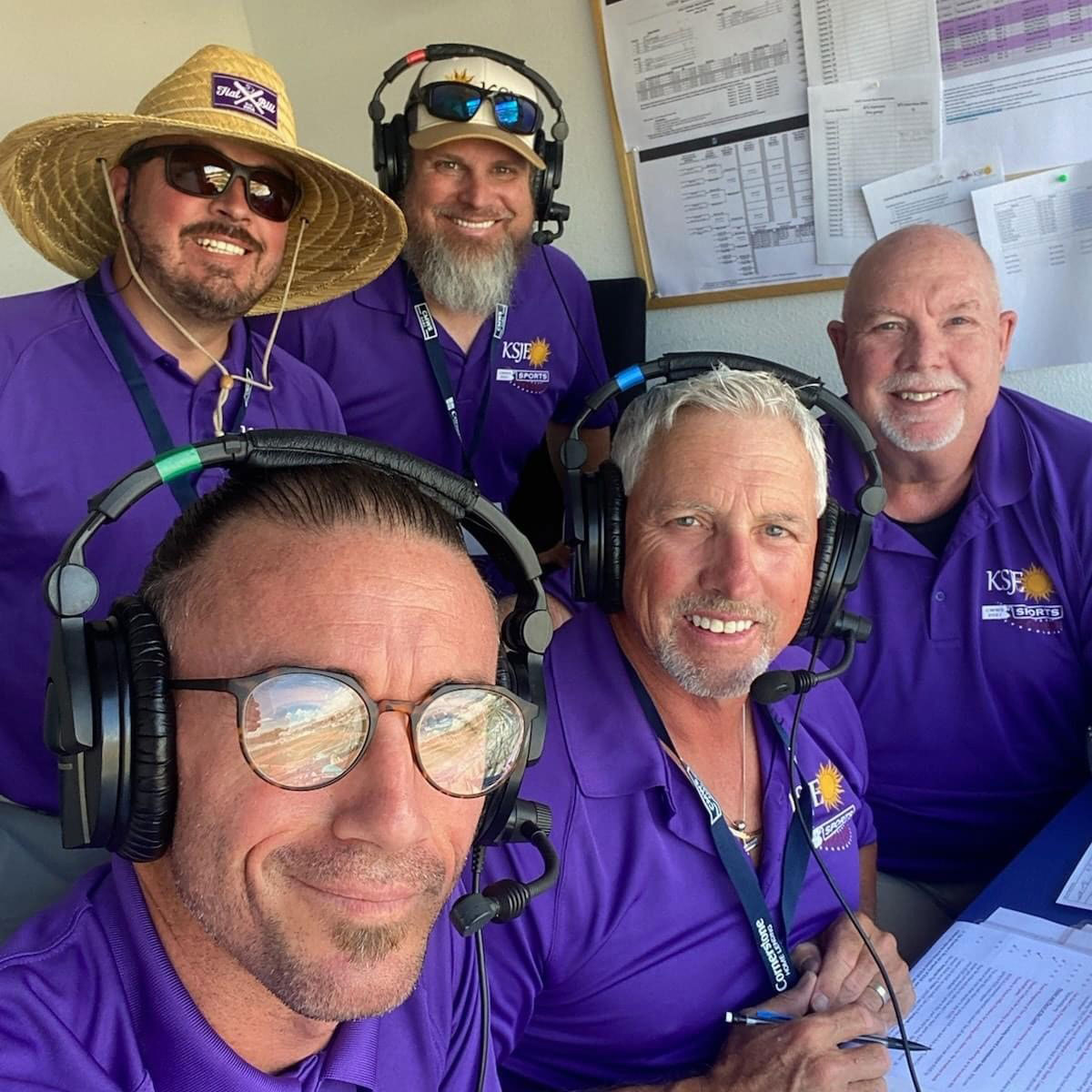 KSJE Connie Mack team members are all smiles in the broadcast booth- left to right Keith Neil, Travis Johnson, Ryan Lane, Kirk Carpenter and Don Lorett.