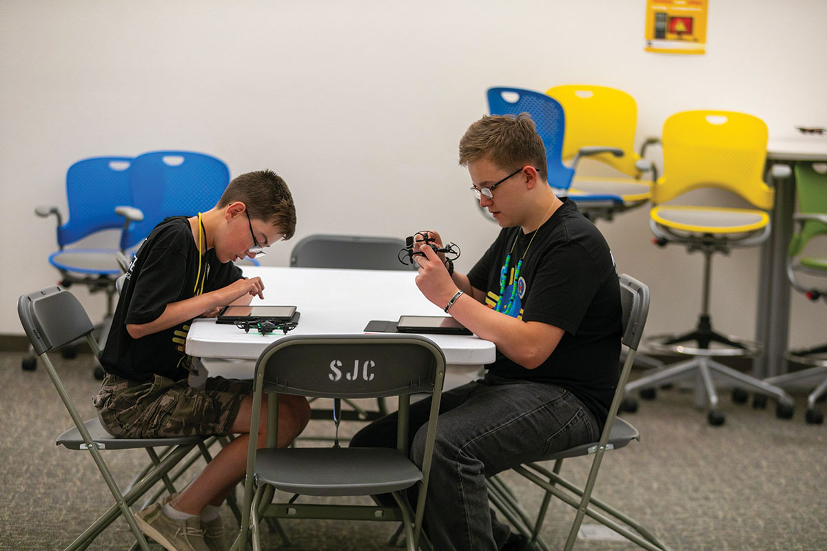 Two students sitting at a table in the GenCyber Program