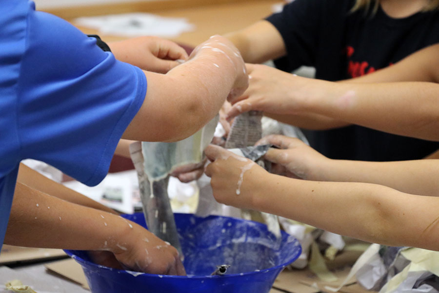 Group of students playing with slime.