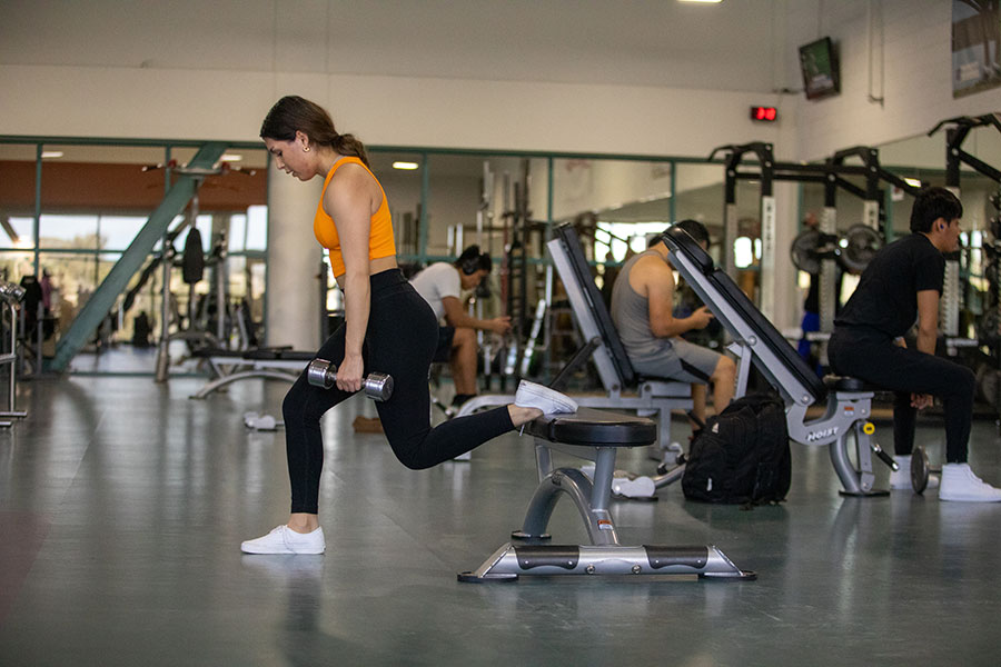 San Juan College Student at the gym working out using their free gym membership.