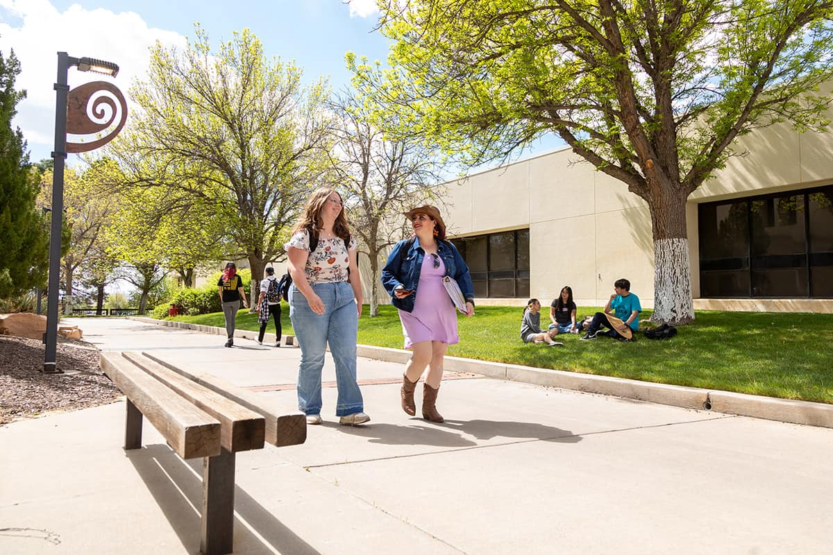College students walk through campus chatting