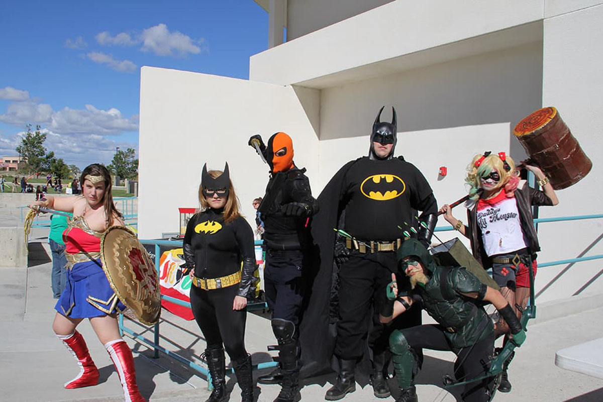 Costume contestants pose in their superhero costumes at family fun day and movie night.
