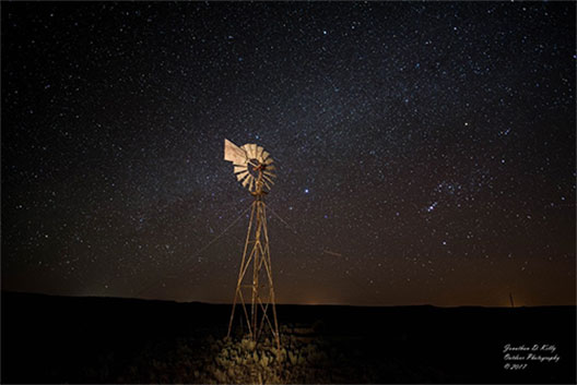 student photo of a windmill and the Milky Way behind it