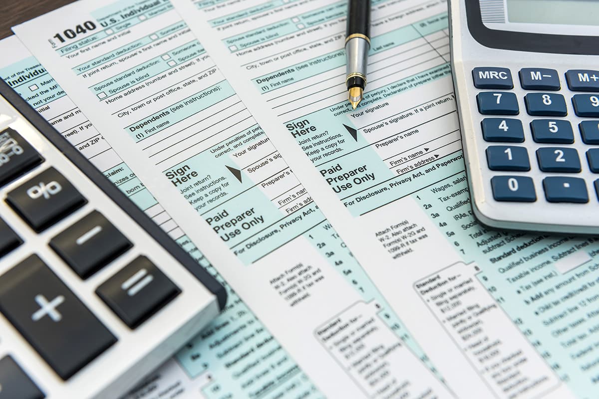 tax forms with calculators and pen