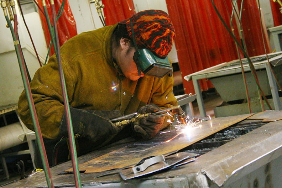 A San Juan College student practicing welding